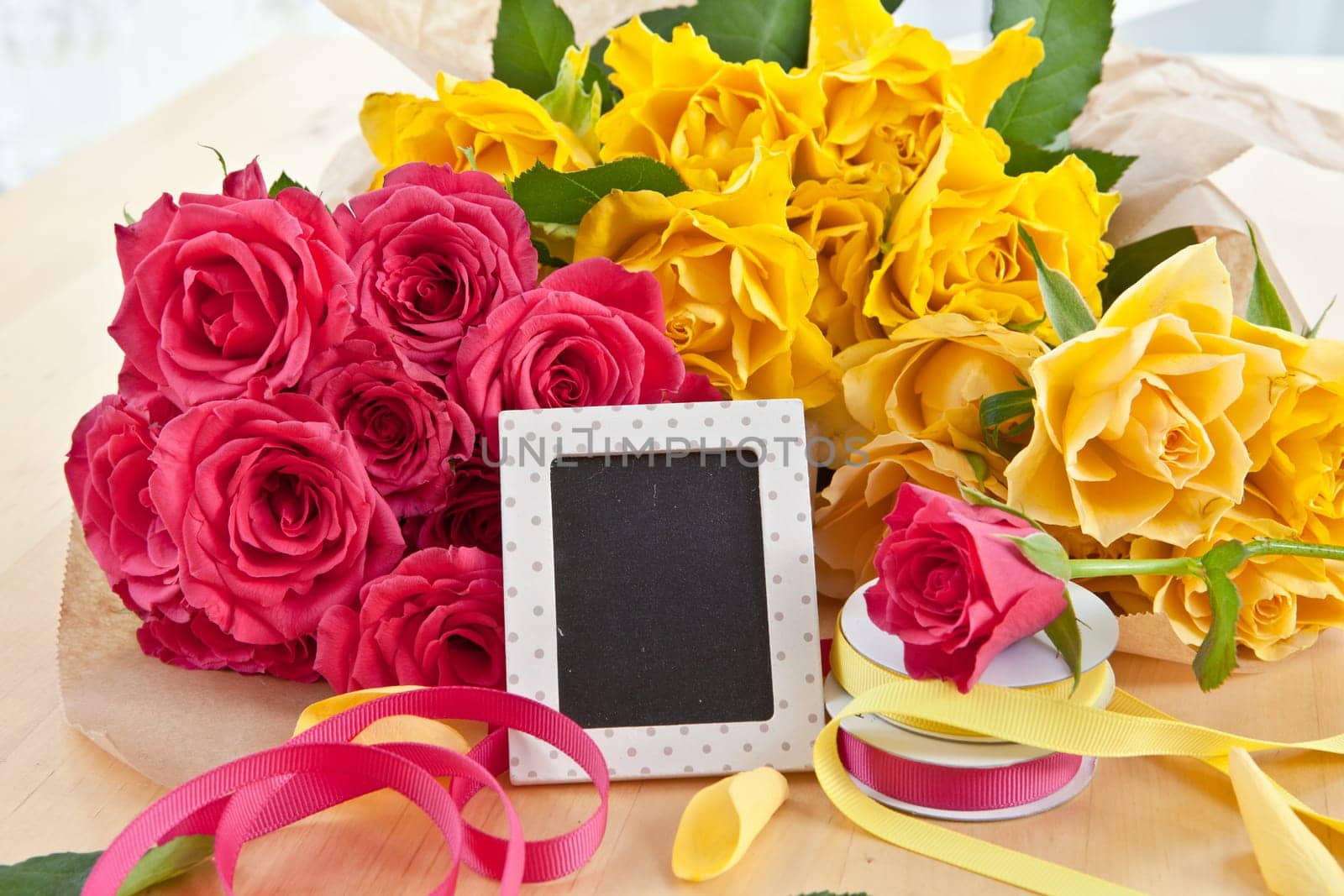 Yellow and pink roses and a small panel with text space