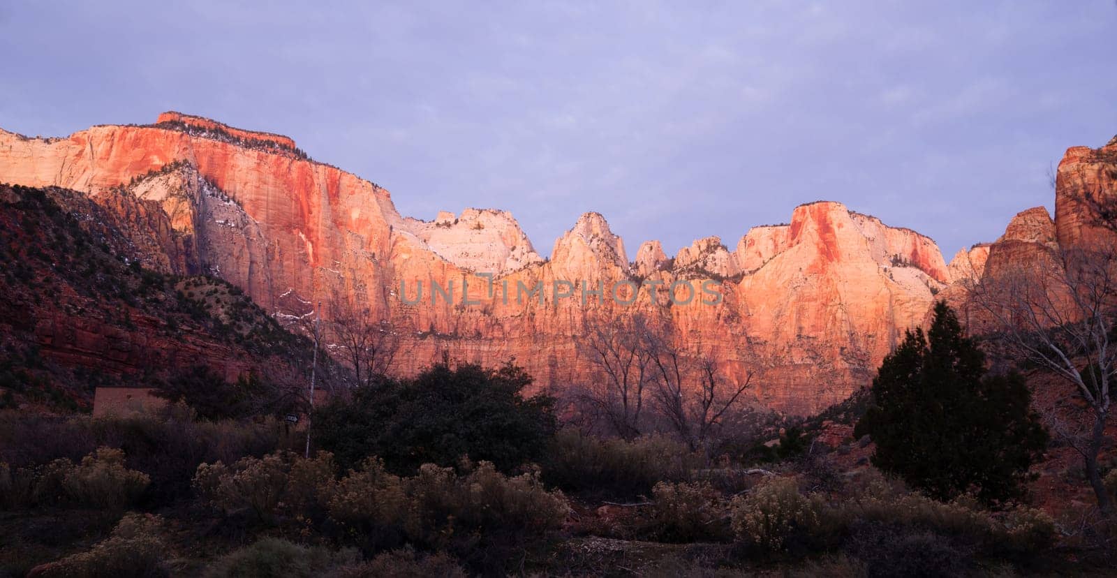 The light has not quite reached the valley int this vertical composition of early morning in the desert Southwest