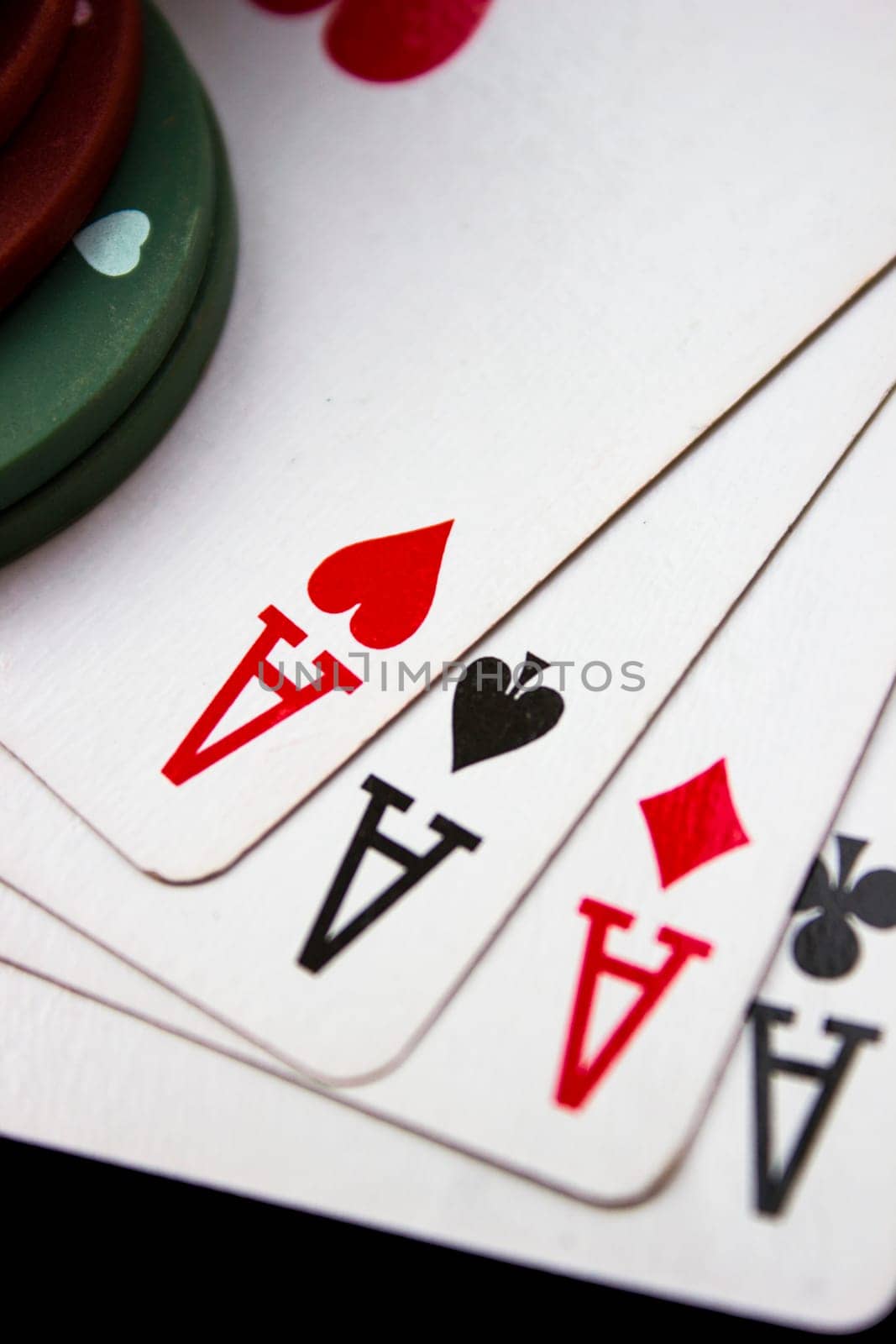 Cards laying around with poker chips on top.