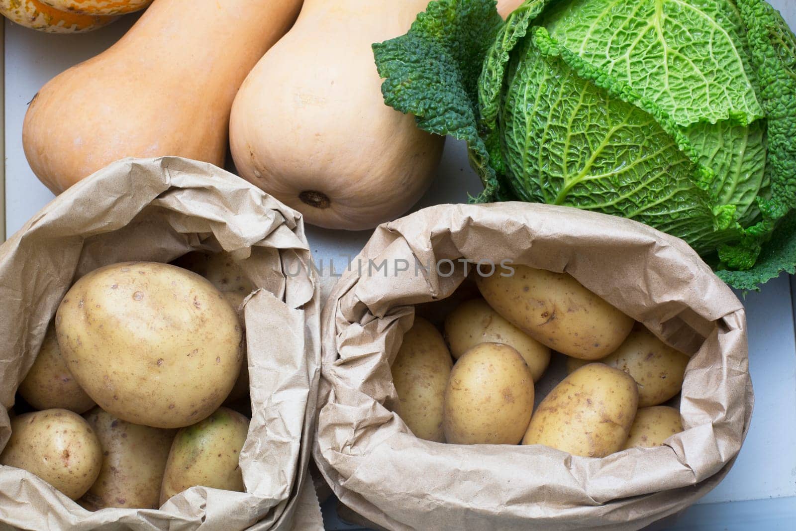 Potatoes, cabbage and butternut squash in drawer.