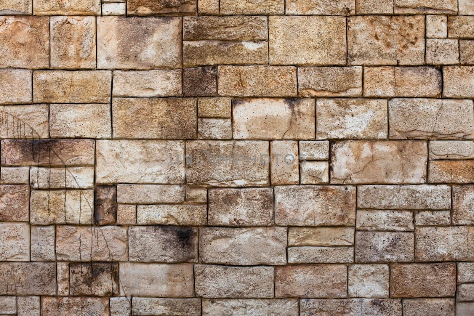 Old stone wall with weathered stones creating interesting patters