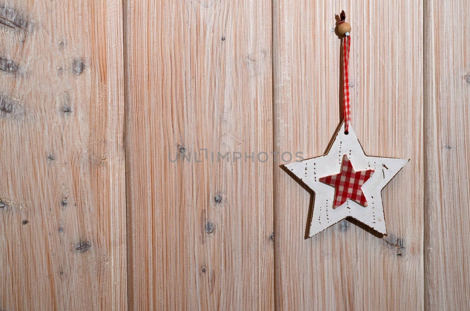 Star hangs on wooden wall