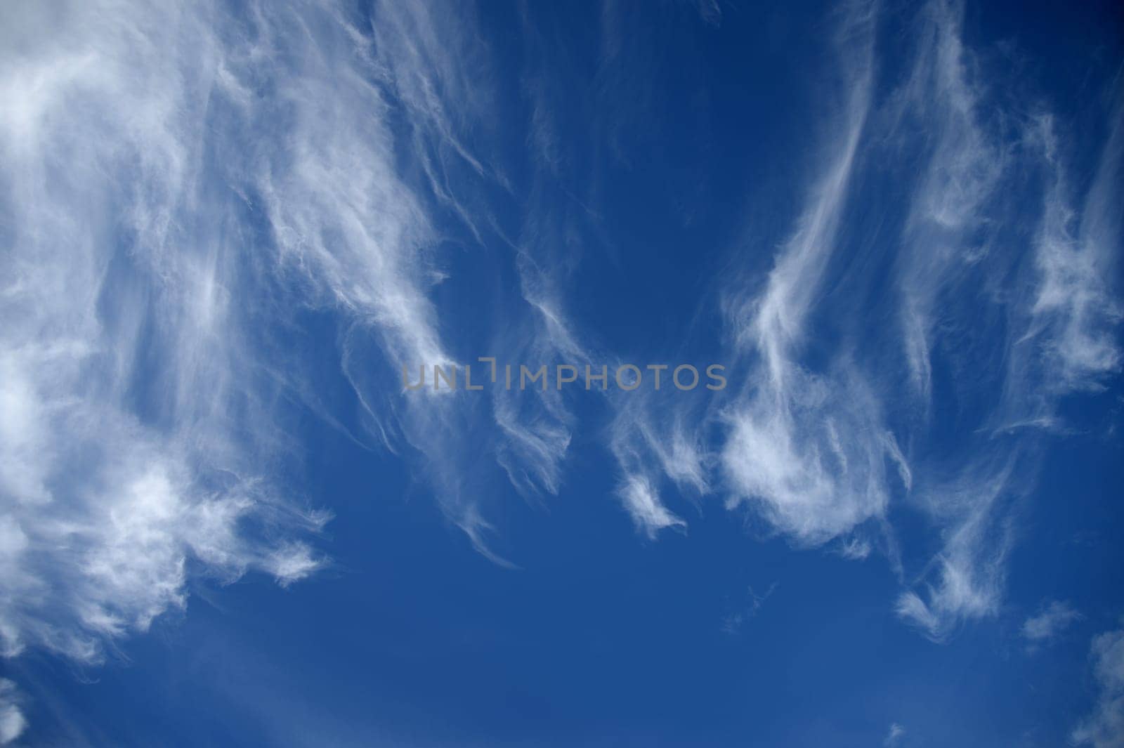 A contrasty blue cloudy sky photographed during the day