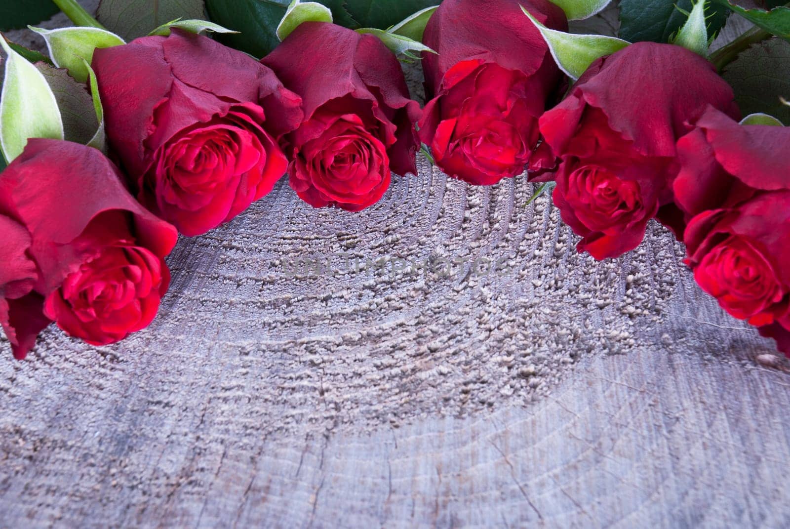 A Wooden Background with Red Roses and Copyspace