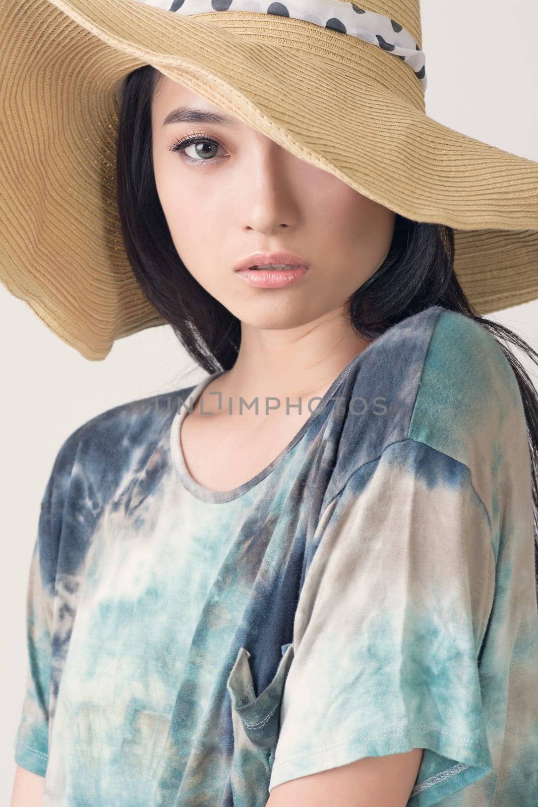 Glamour of Asian beauty with hat, closeup portrait.