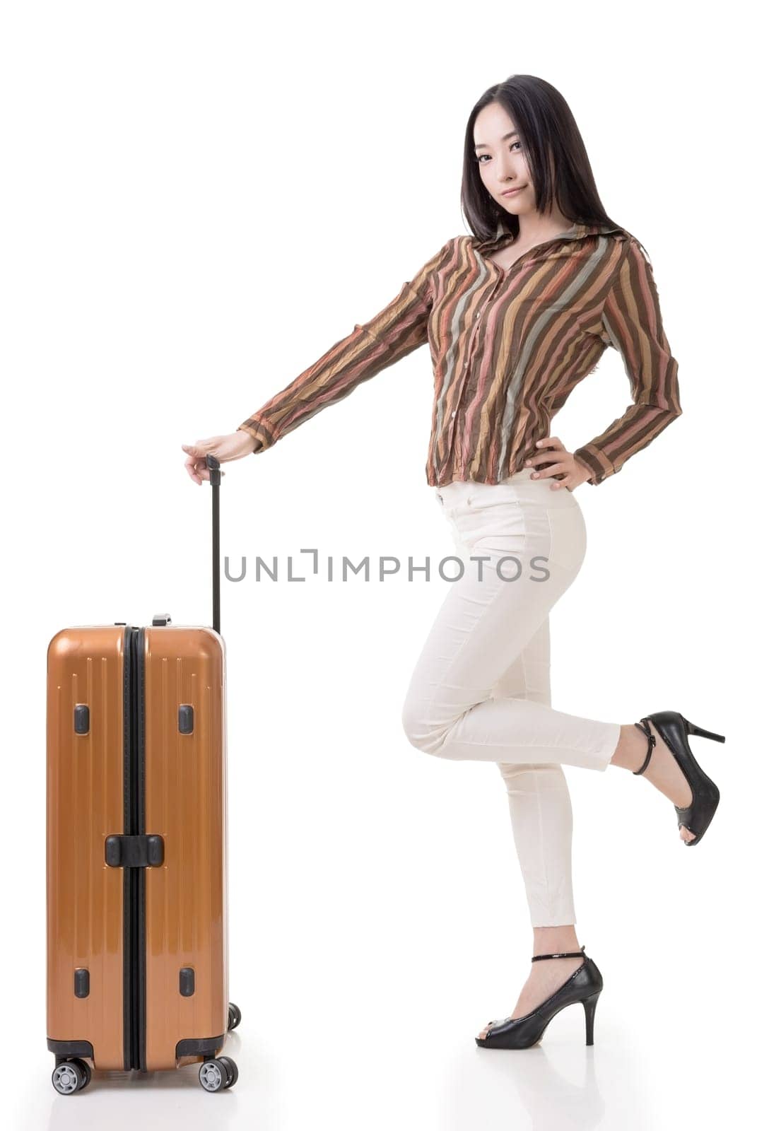 Modern Asian woman stand with a luggage, full length portrait on white background.