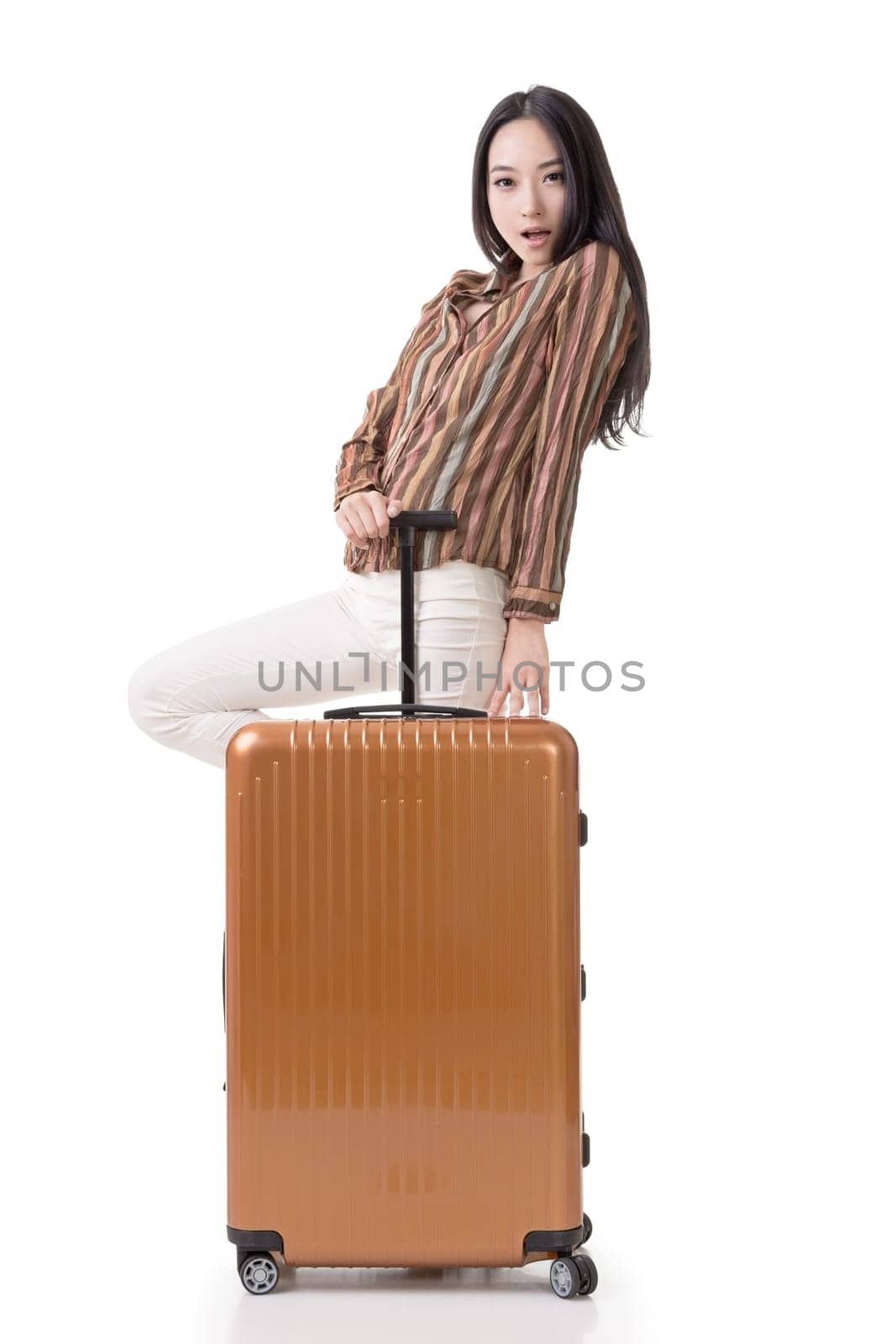 Modern Asian woman stand with a luggage, full length portrait on white background.