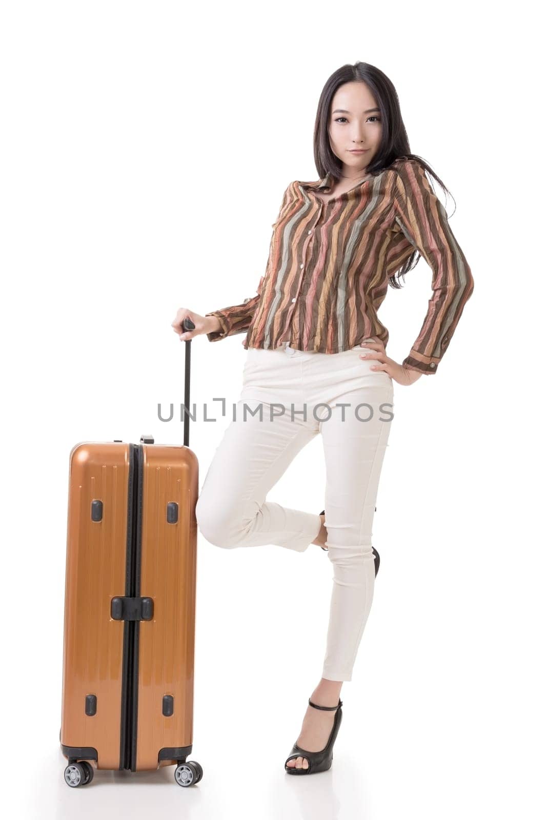 Modern Asian woman stand with a luggage, full length portrait on white background.