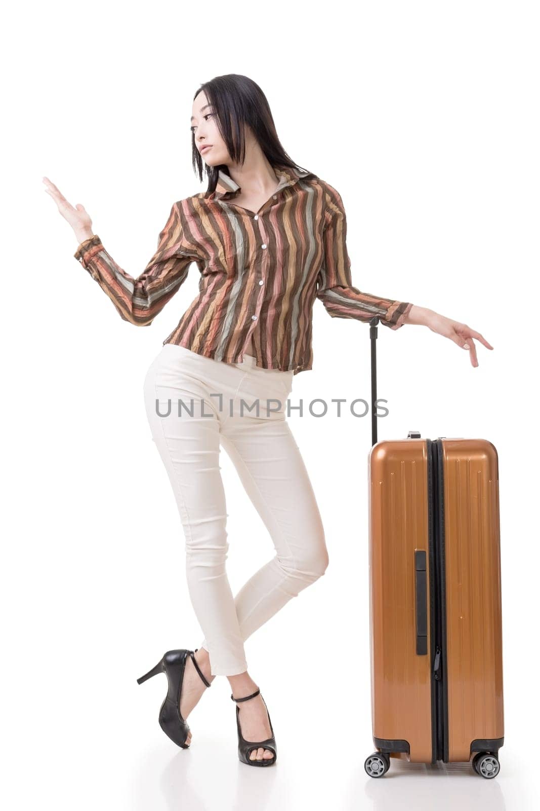 Modern Asian woman stand with a luggage, full length portrait on white background.