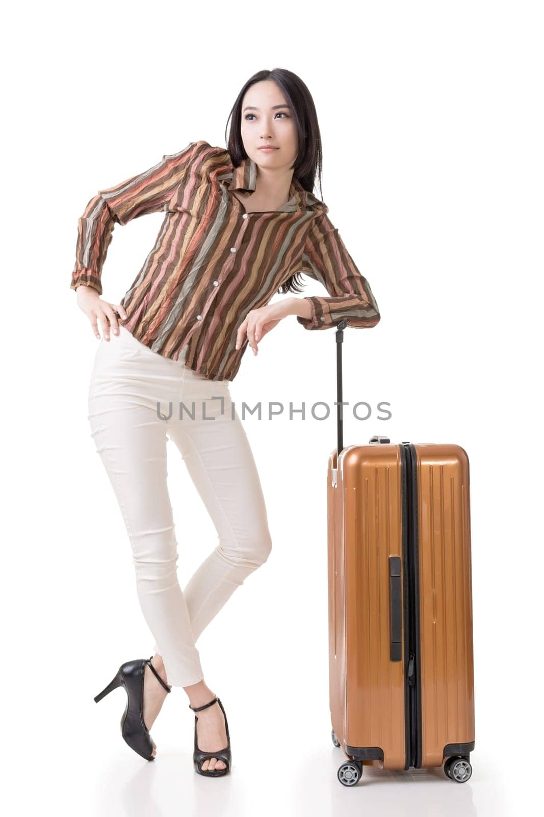 Modern Asian woman stand with a luggage, full length portrait on white background.