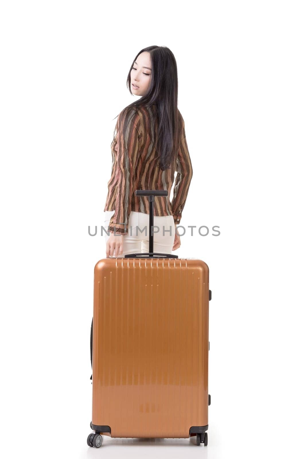 Modern Asian woman stand with a luggage, full length portrait on white background.