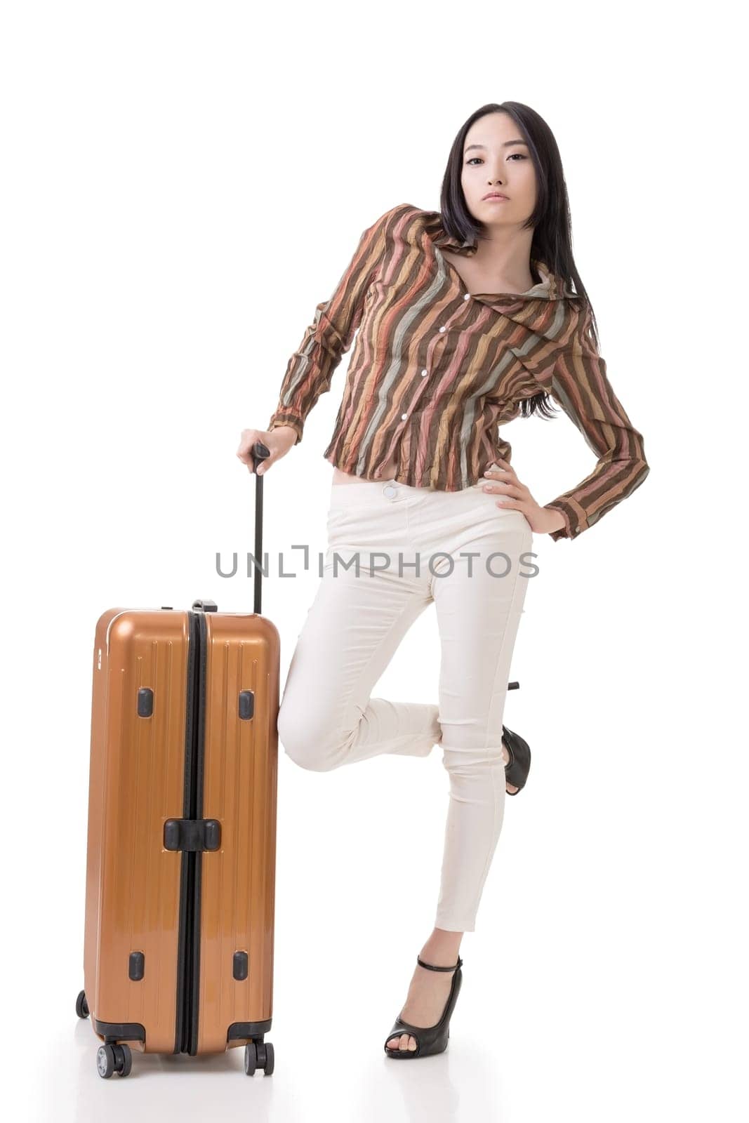 Modern Asian woman stand with a luggage, full length portrait on white background.