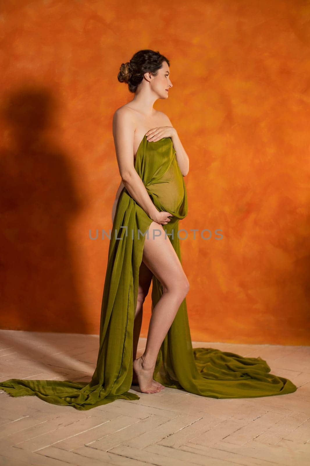 Pregnant woman on orange background by zokov