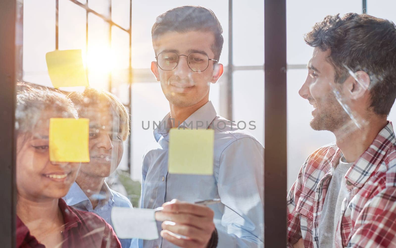 Group of business people behind glass wall at office