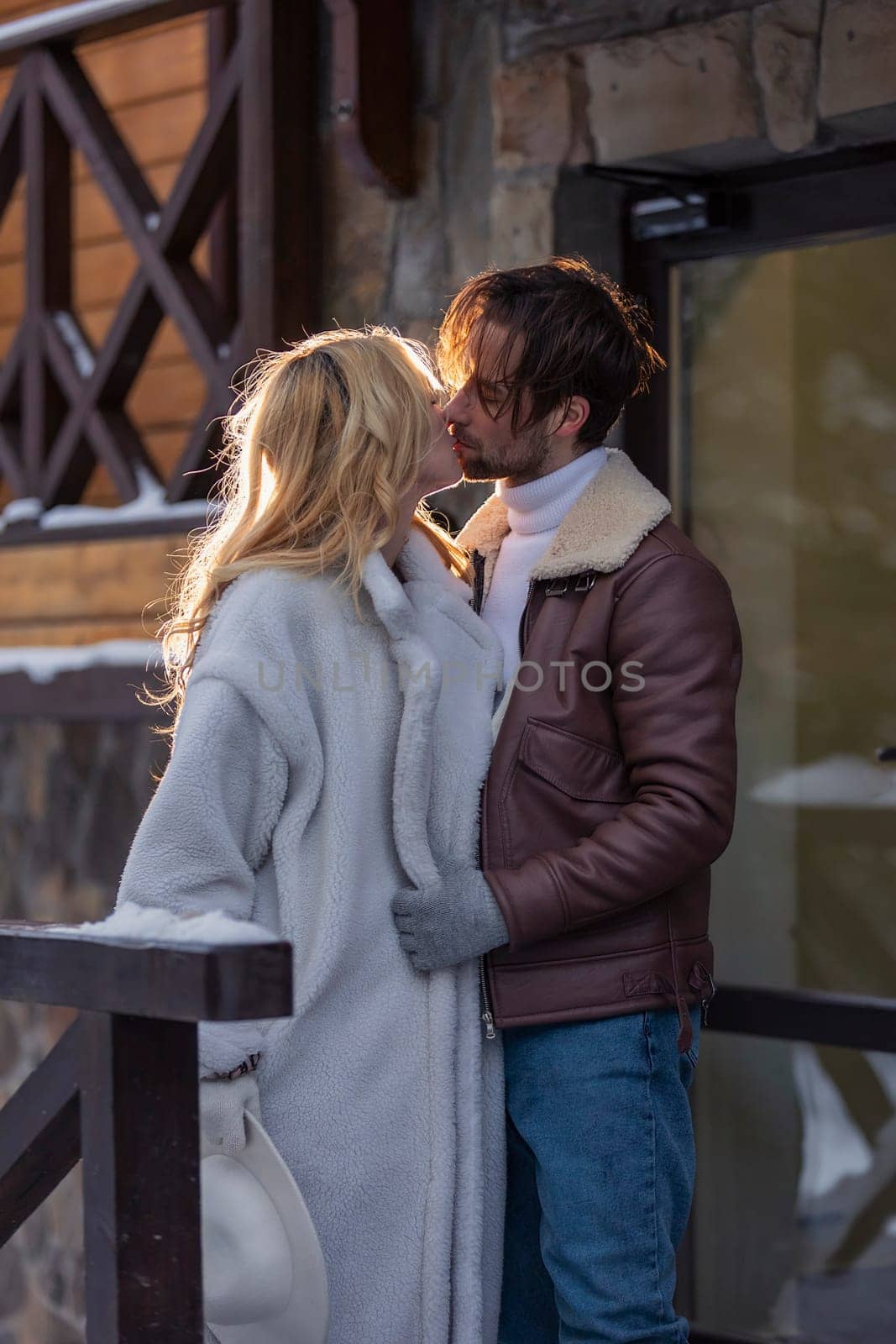 young couple hugging near the door outdoors