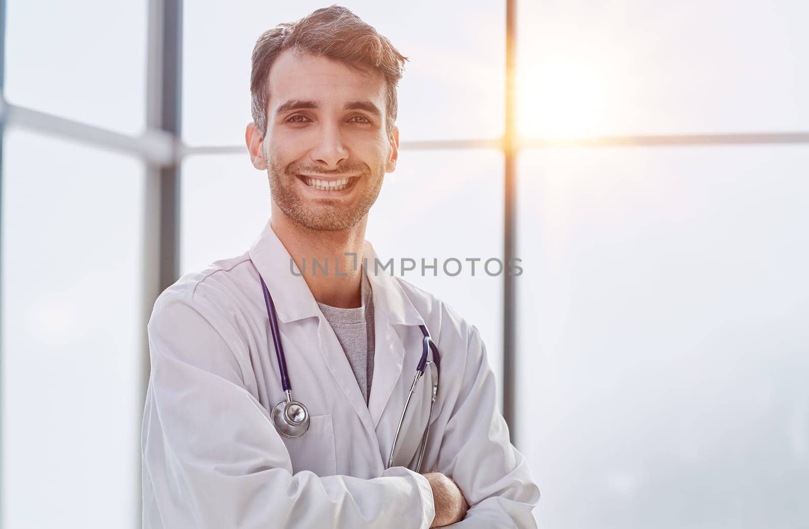 man smiling and looking at camera, doctor student intern with stethoscope by Prosto