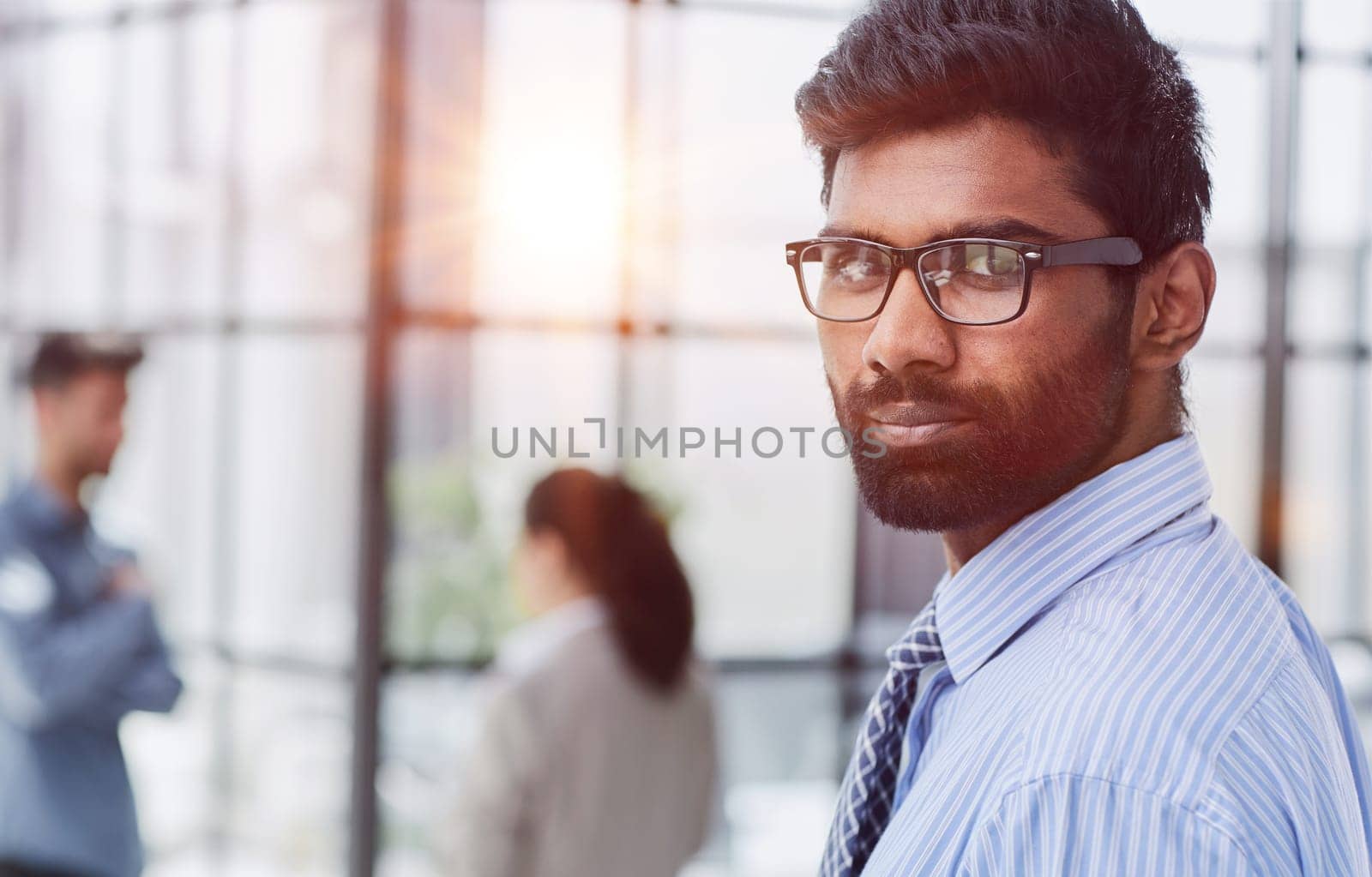 male investor beard looking at camera and smiling in modern office