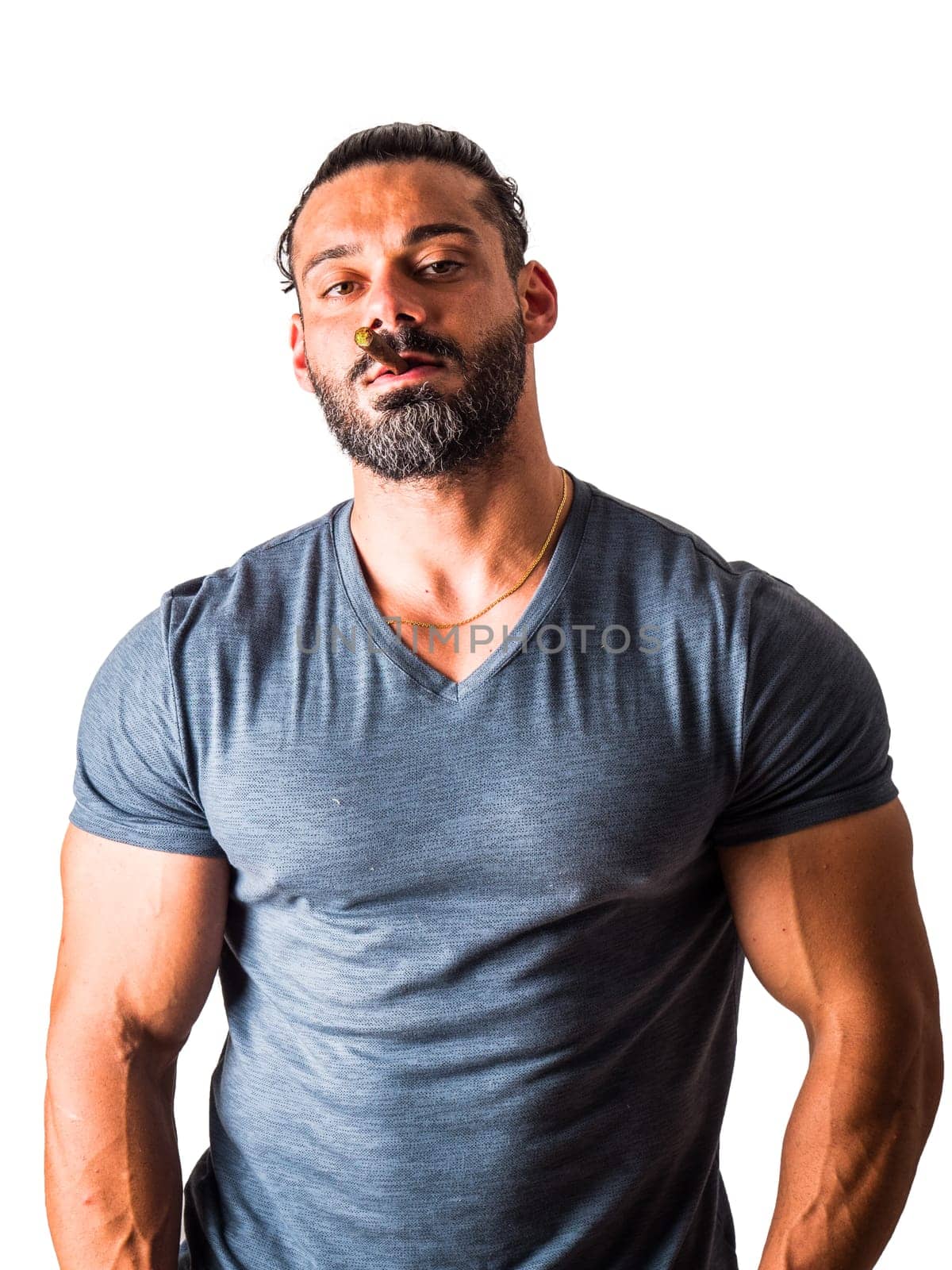 A man with a beard wearing a v - neck shirt smoking a cigar