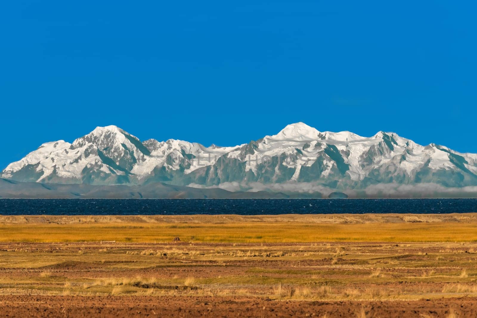 Bolivian mountains from peruvian Andes Titicaca Lake at Puno Peru