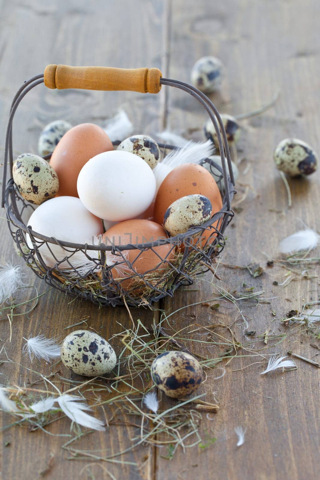 Vintage wire basket with various raw eggs for Easter