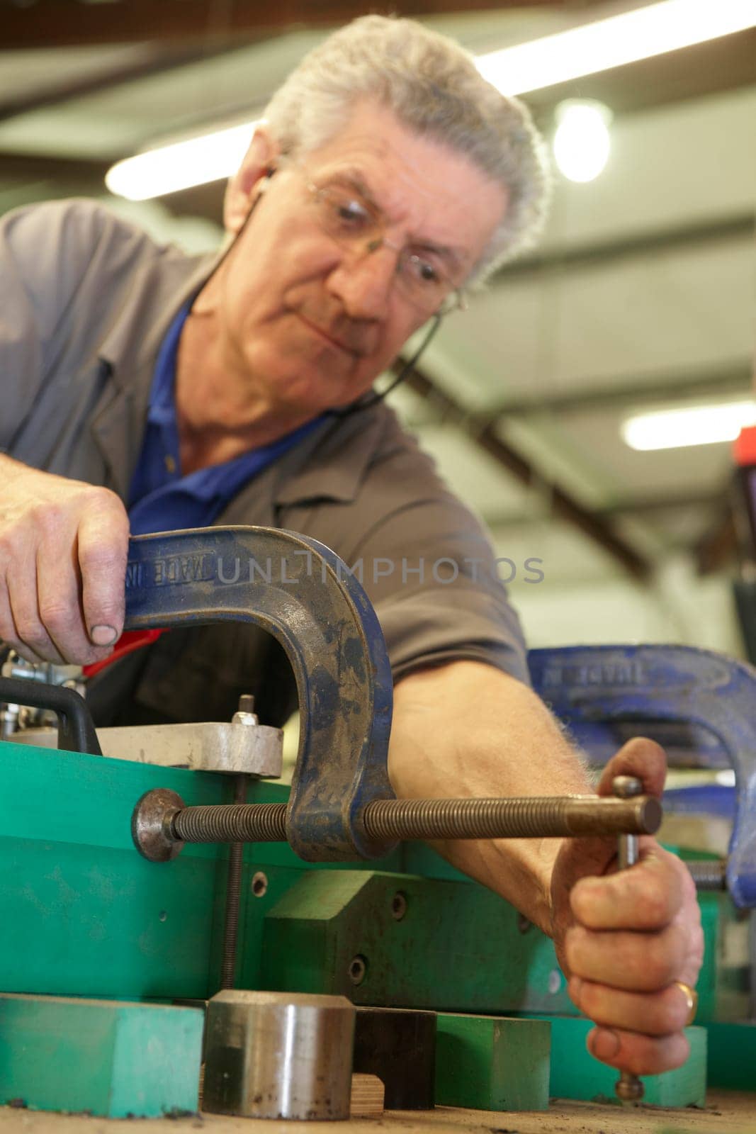 senior worker cleaning his hands with a cloth