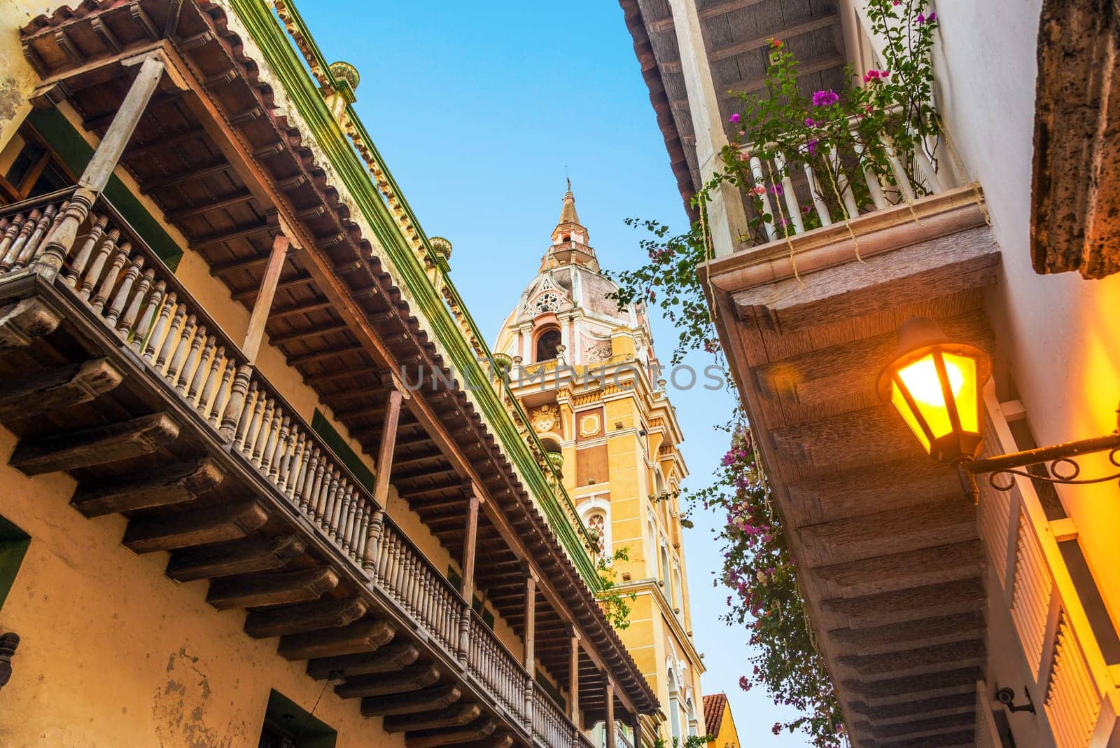 View looking up at historic colonial balconies and a church in Cartagena, Colombia