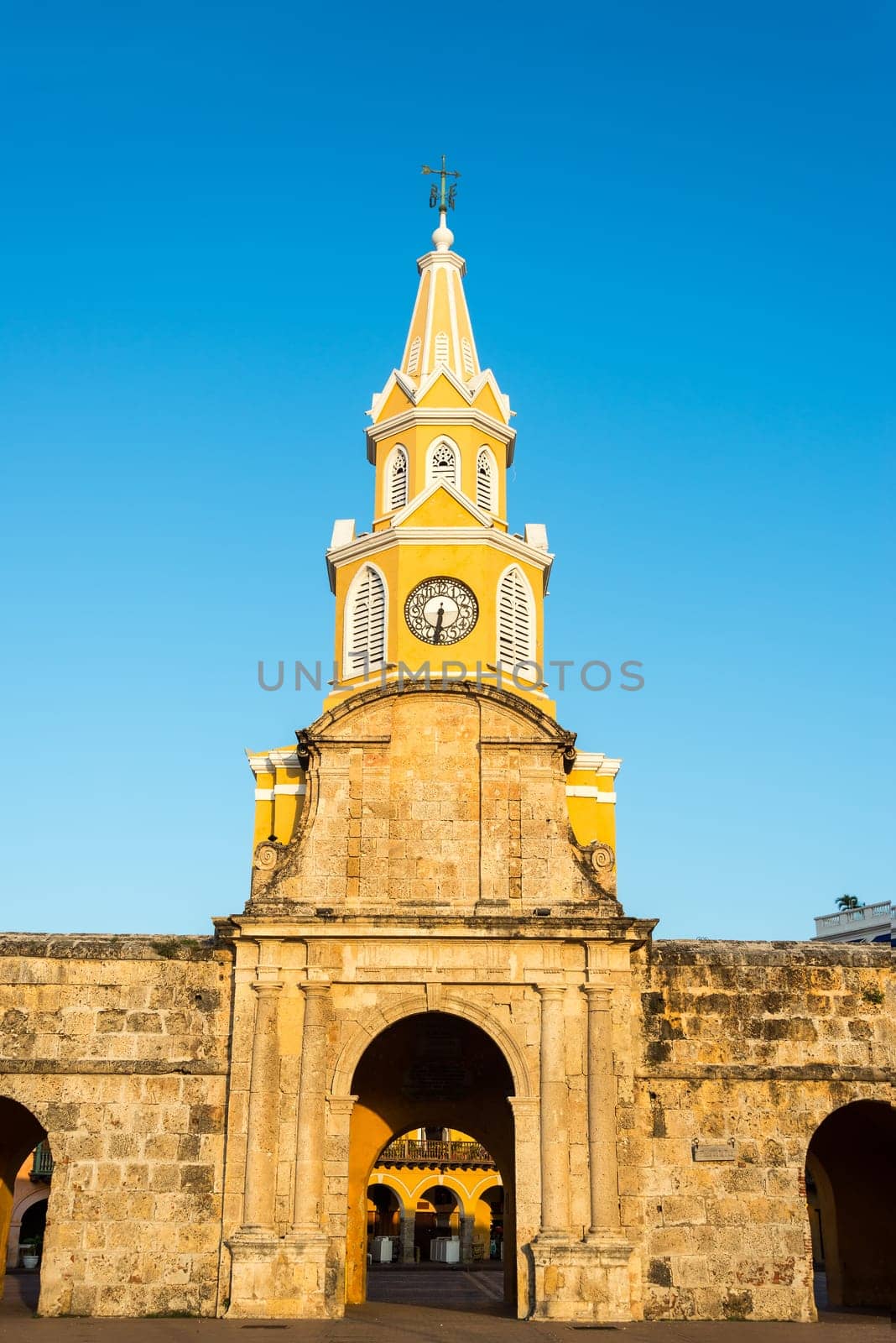 Vertical view of the clock tower gate at sunrise in the historic center of Cartagena, Colombia