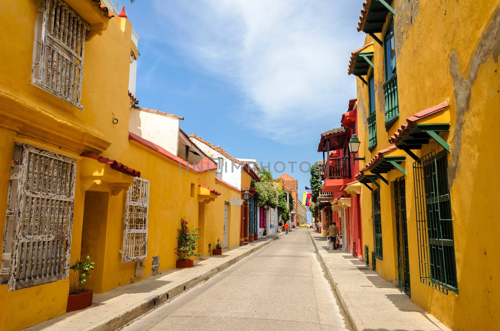 Typical street scene in Cartagena, Colombia of a street with old historic colonial houses on each side of it