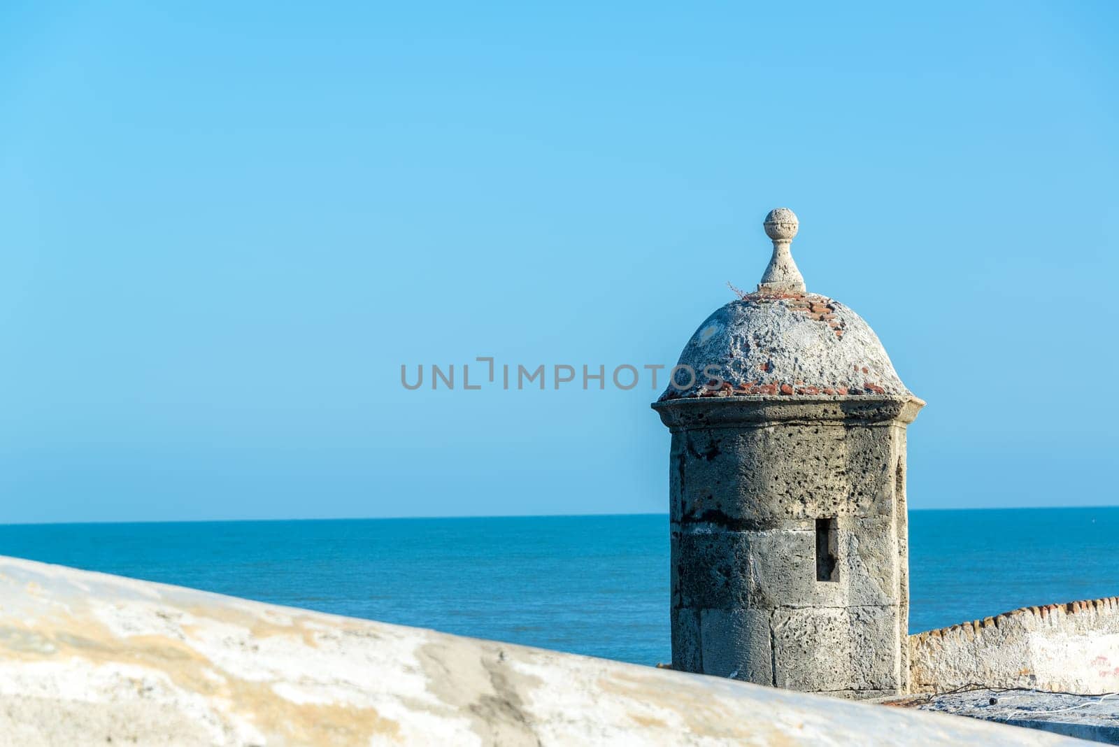 View of the defensive wall surrounding the old city of Cartagena, Colombia with the Caribbean Sea visible in the background