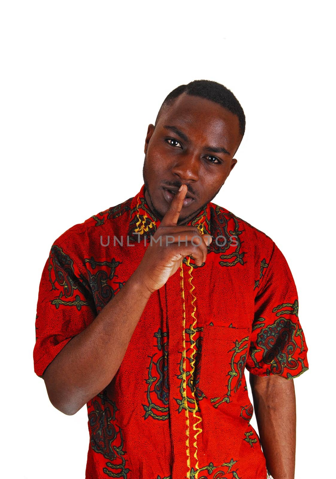 A handsome young black man in a colorful red shirt with one finger on his.mouth, for white background..