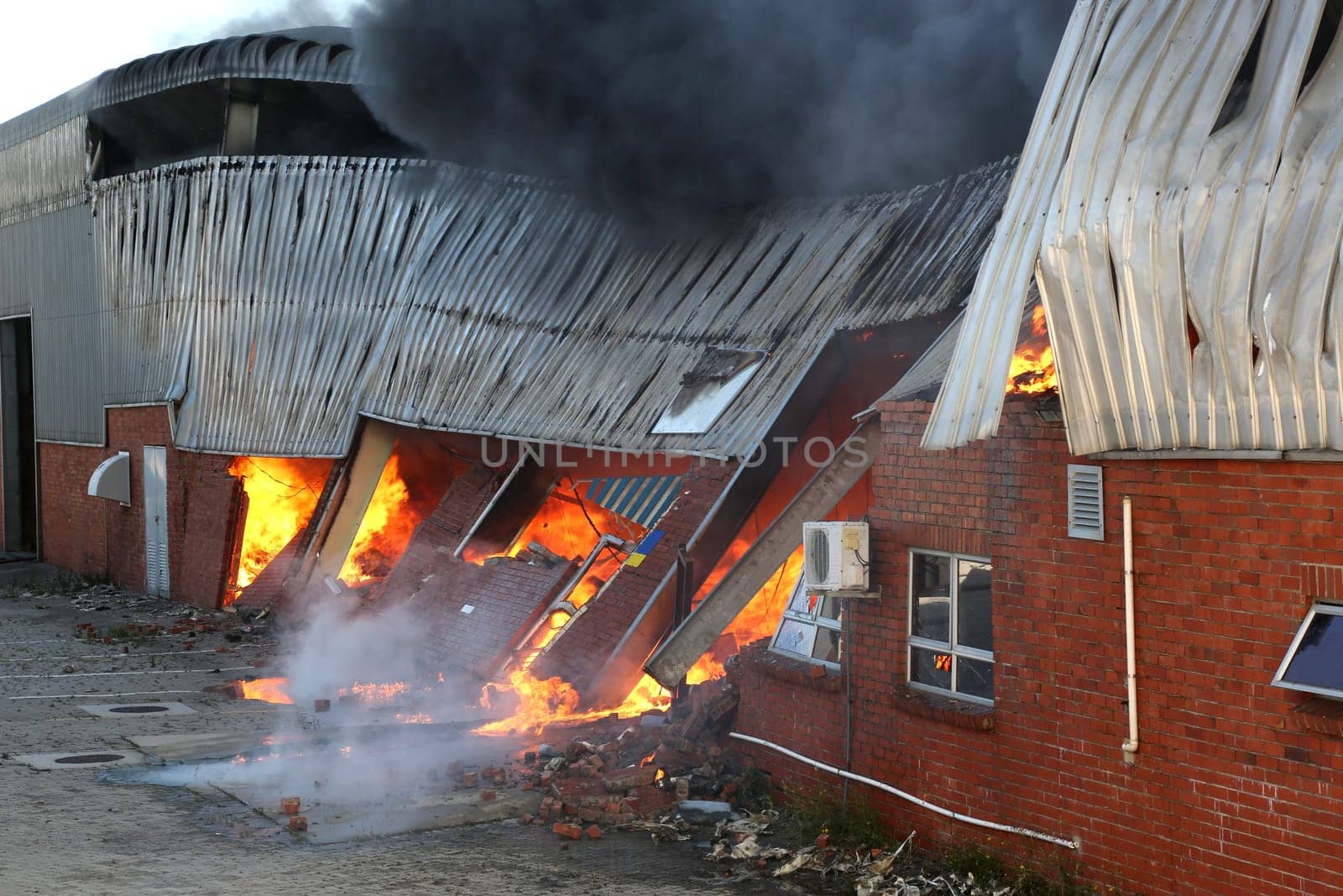 Warehouse building burning with intense flames