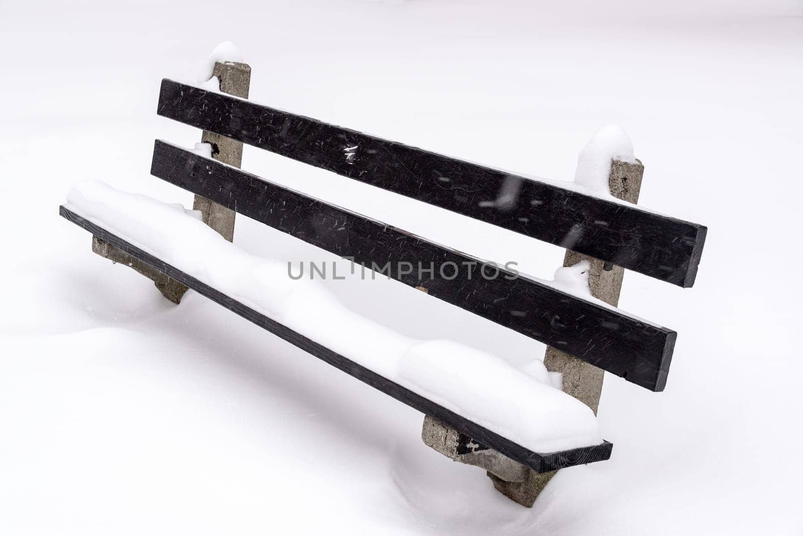 Park bench covered in snow in Wicker Park in Chicago