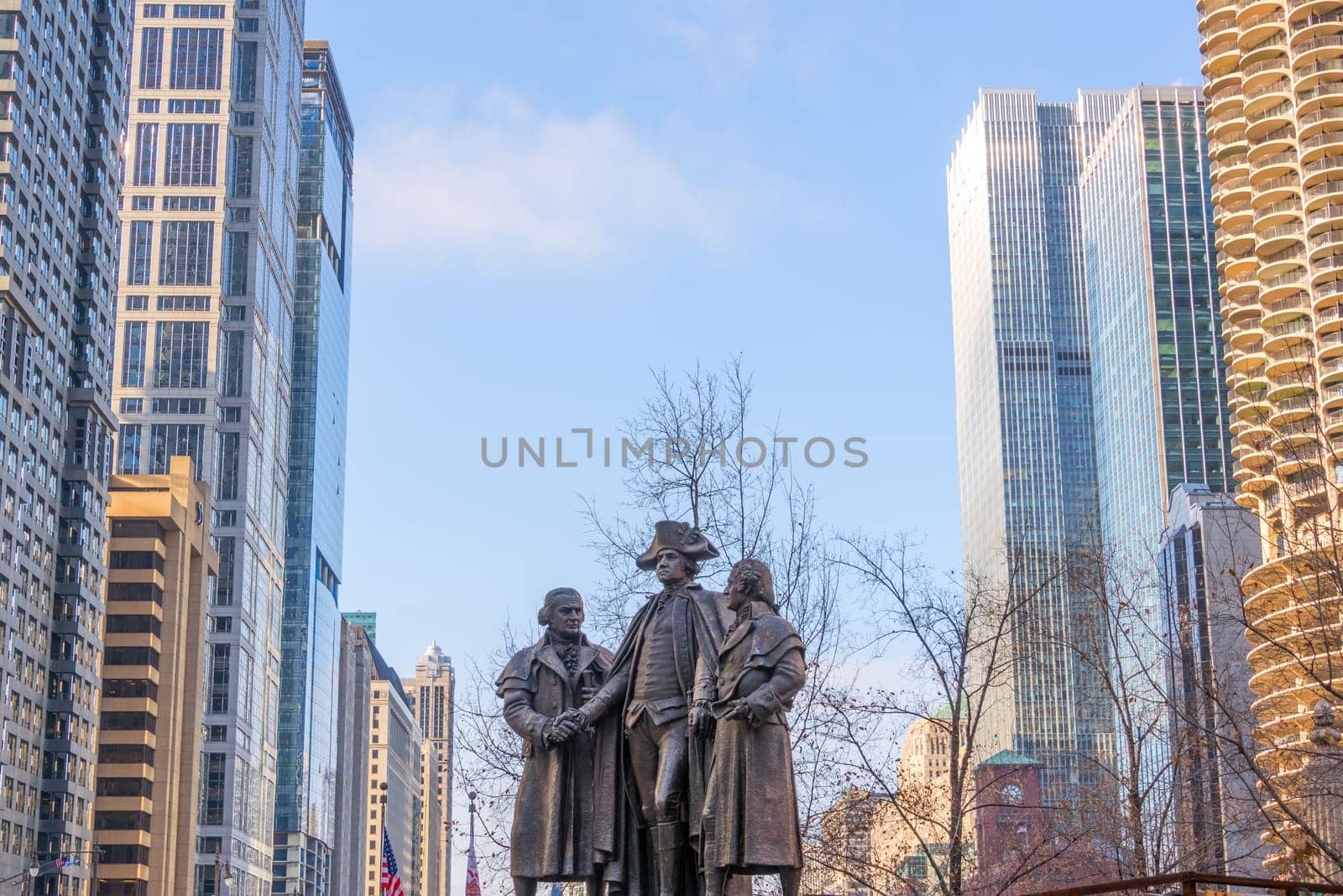Public statue of George Washington with skyscrapers on either side in downtown Chicago