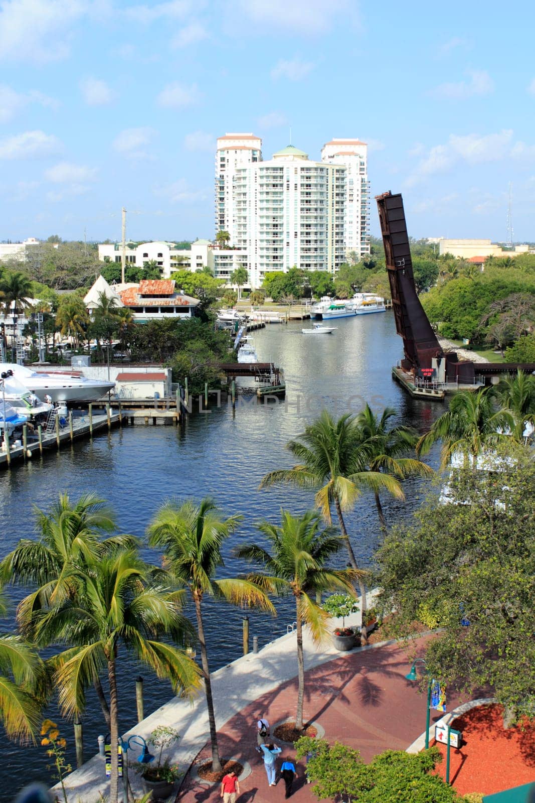 FORT LAUDERDALE, FLORIDA - MARCH 23, 2013: High above view of Riverwalk Park and New River waterway in downtown with people walking on the brick sidewalk on a pleasant winter day.