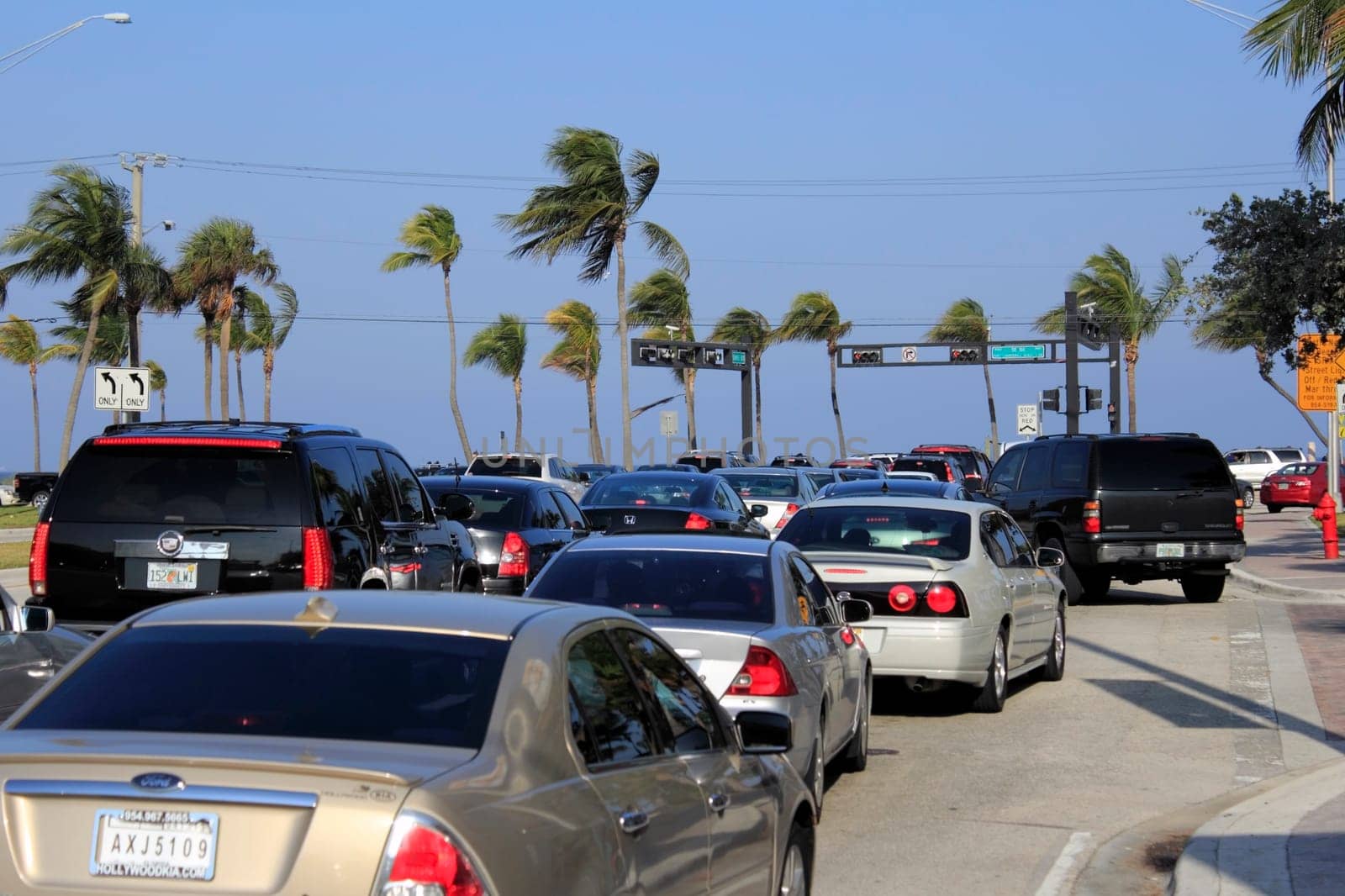 FORT LAUDERDALE, FLORIDA - MARCH 23, 2013: Intersection at Sunrise Boulevard and State Road A1A near the beach during the day with many vehicles waiting for the traffic signal during spring break.
