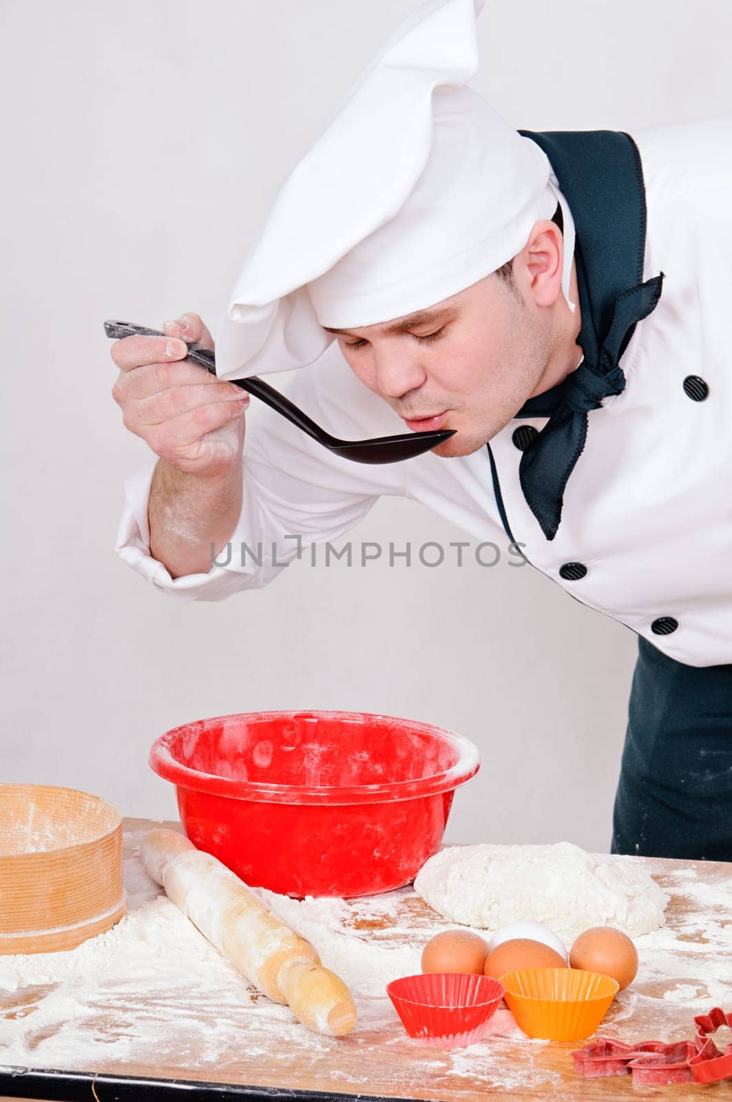 chef with large spoon on the gray background
