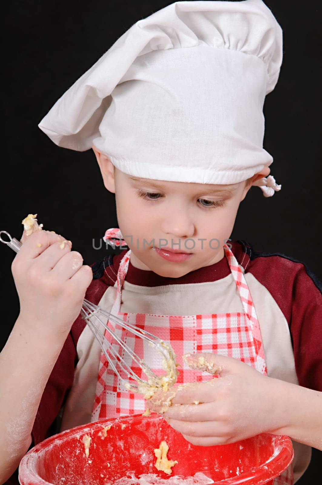 boy in chef hat knead the dough