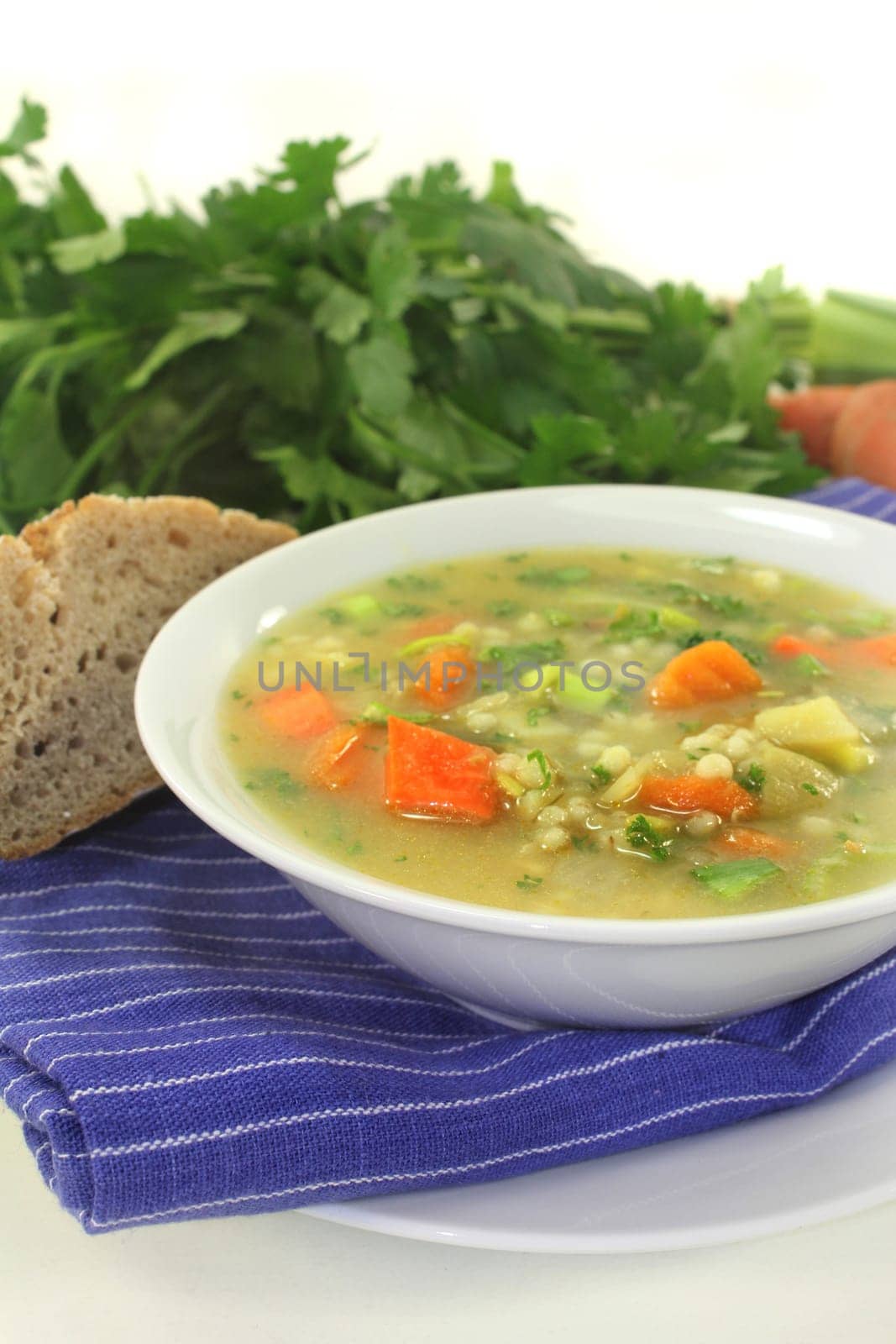 a white bowl of colorful pearl barley soup