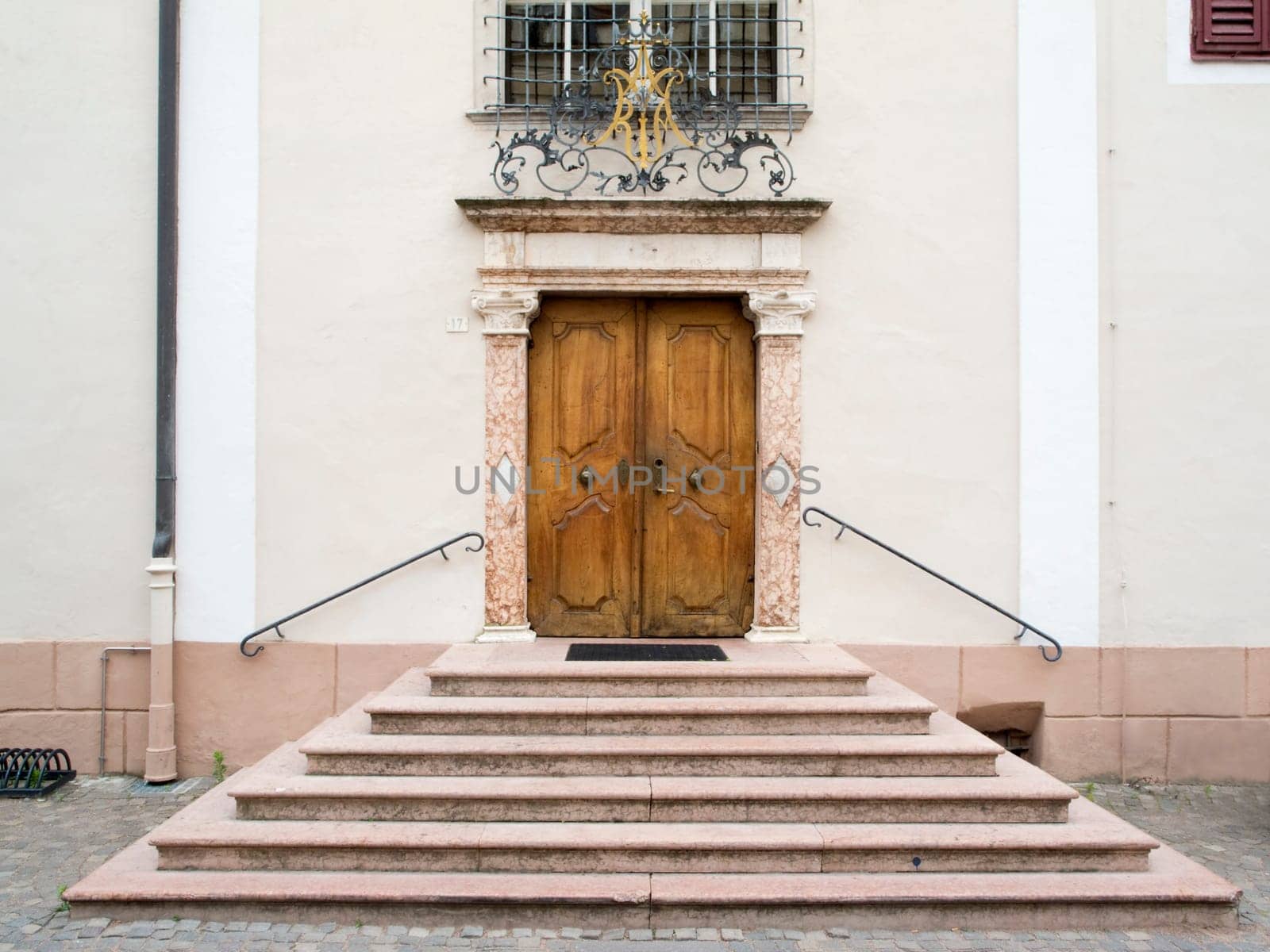 frontal view of a portal with stairs and ancient double-wing door in Merano / South Tyrol in the Tappeiner Weg  Summer 2013