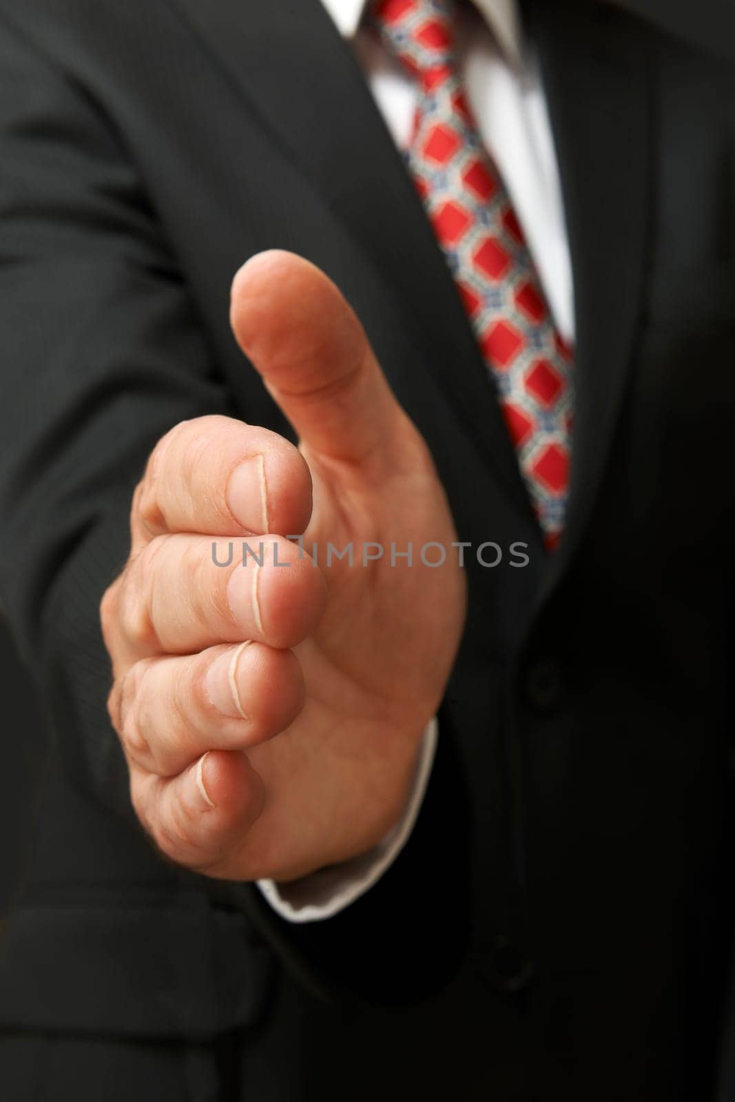 closeup of businessman's hand outstretched for a handshake