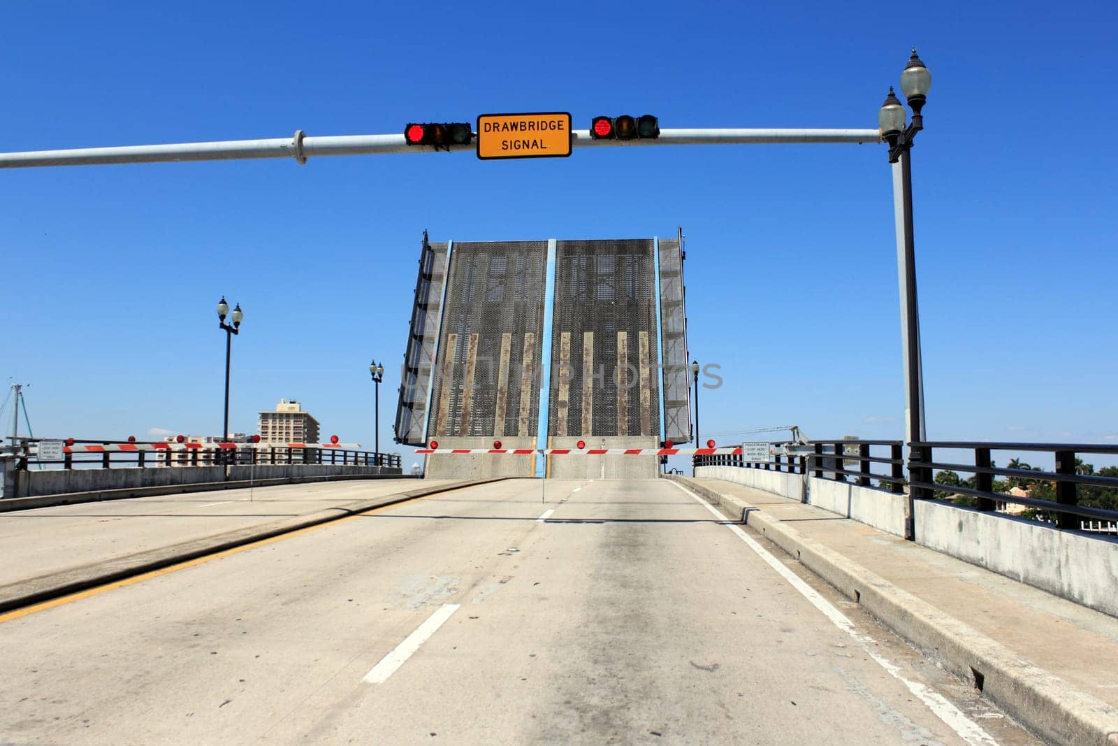 FORT LAUDERDALE, FLORIDA - MARCH 30, 2013: Red stop lights on the East Las Olas Boulevard drawbridge raised over the Atlantic Intracoastal waterway with a bright blue sky winter in the background.