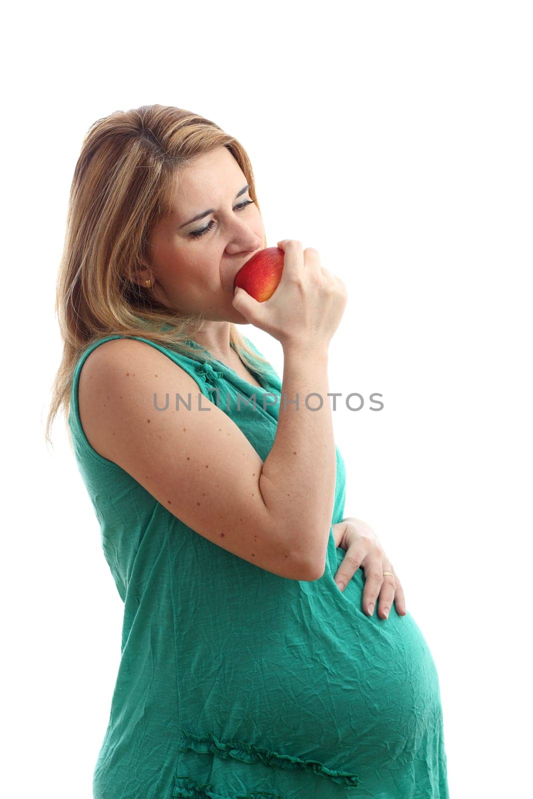 Details of a pregnant woman with an apple isolated on white background.