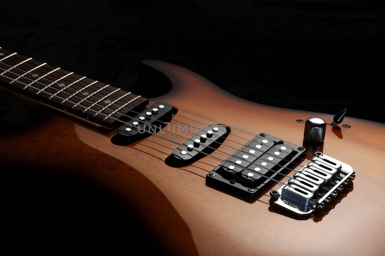 close up of a electric guitar on dark background