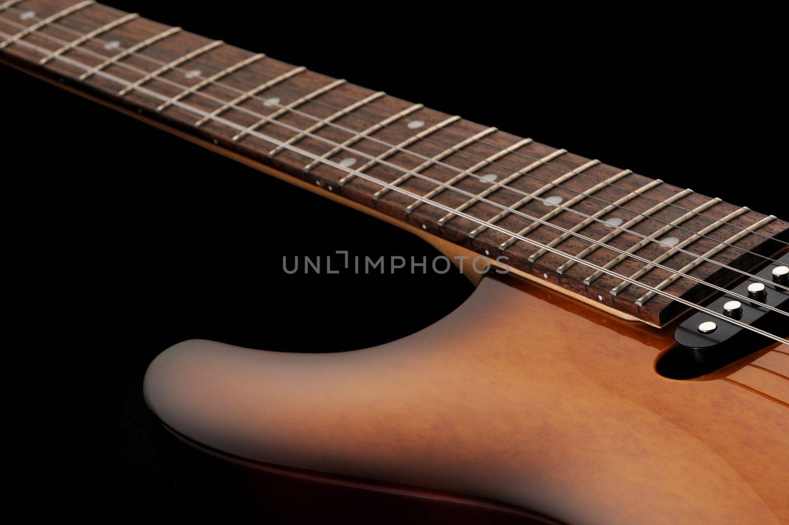 close up of a electric guitar on dark background