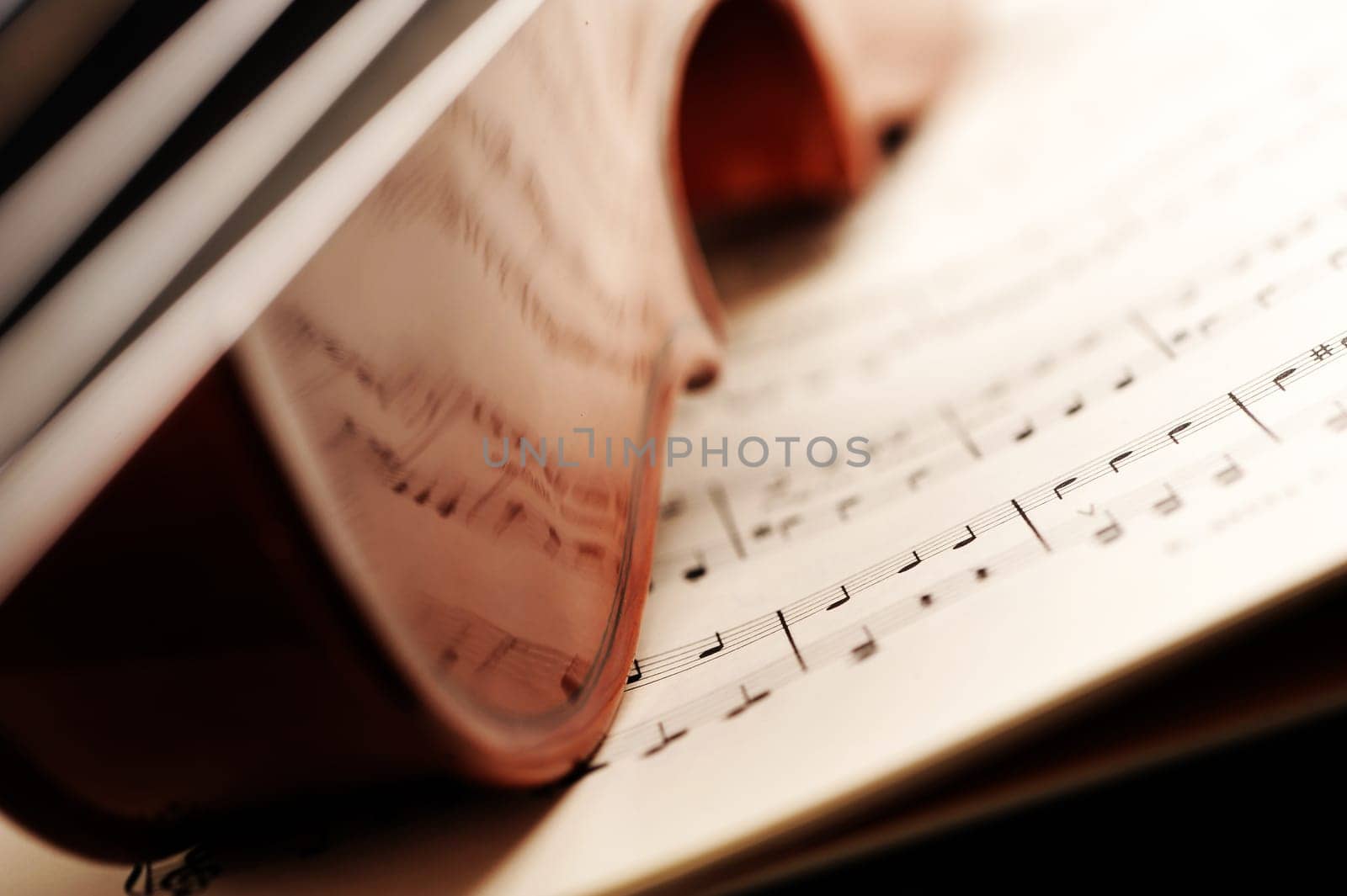 violin on a music sheet, shallow deep of field