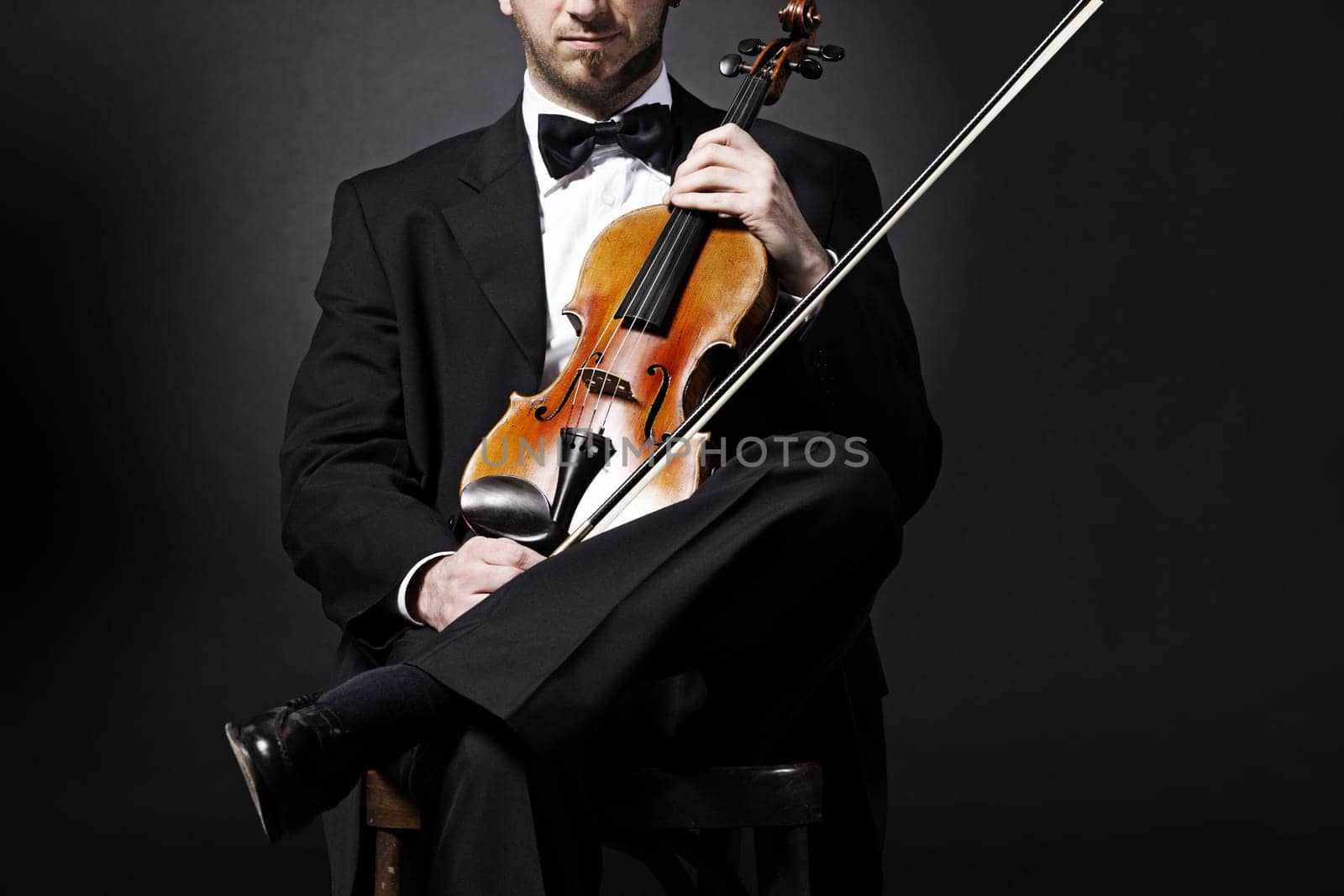 an elegant violinist with his violin