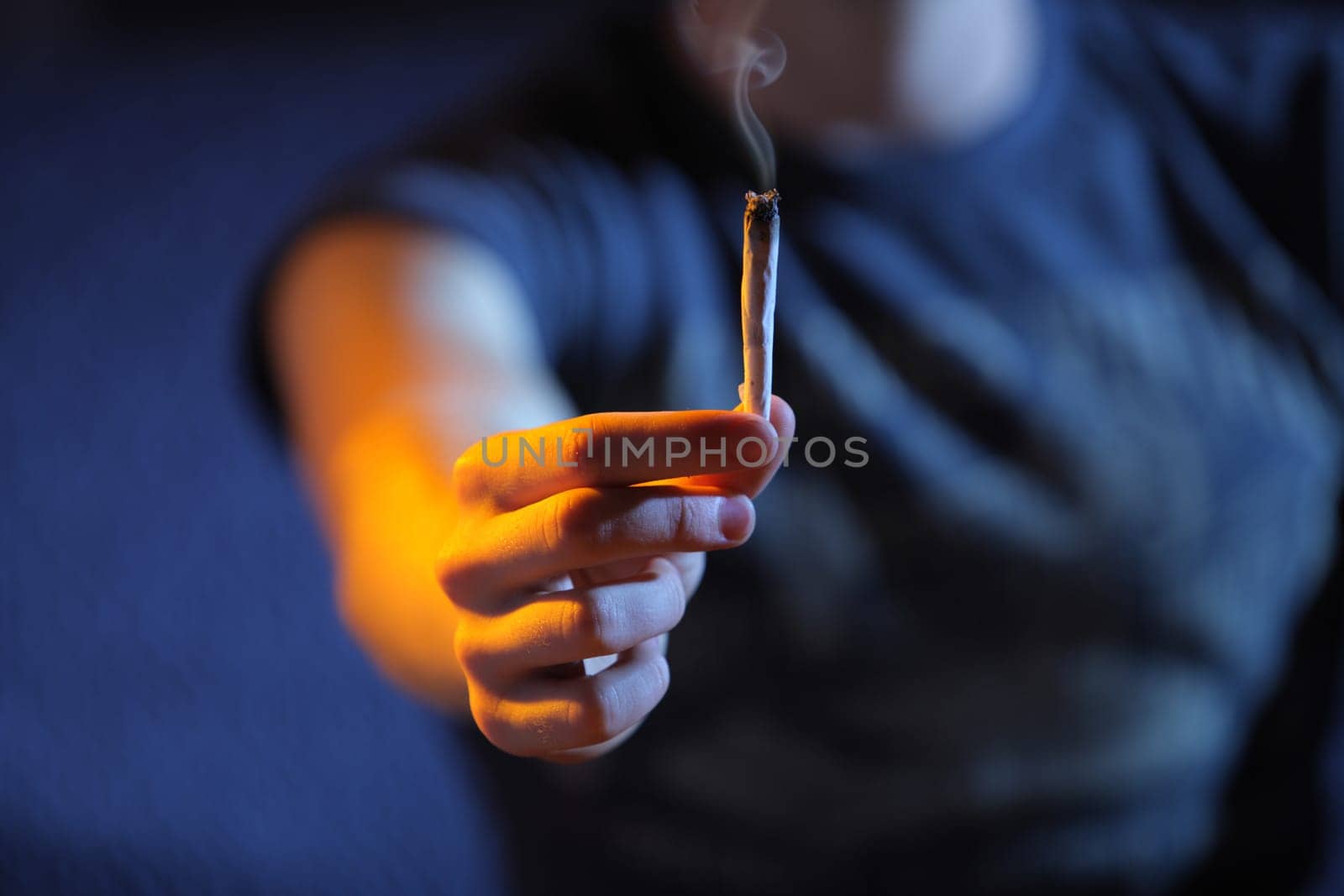 Smoking joint. Hand close up. Copy space