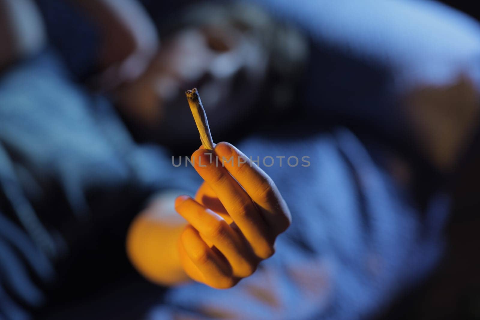 Smoking joint. Hand close up