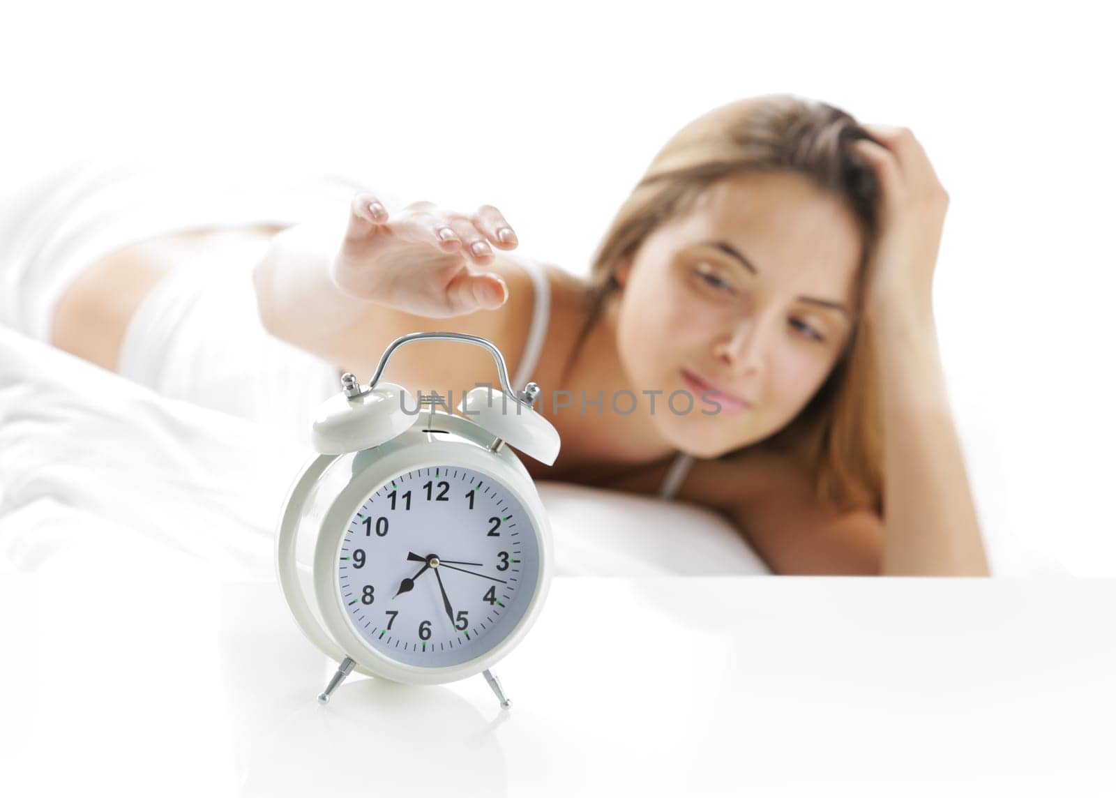 Woman turning off the alarm clock
