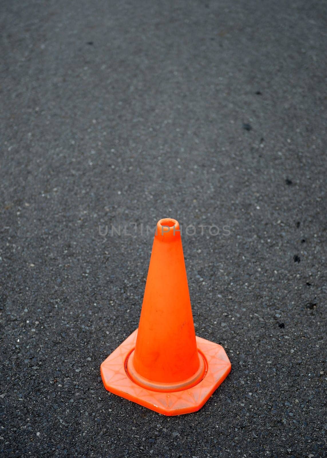 A close up shot of a safety cone on a road